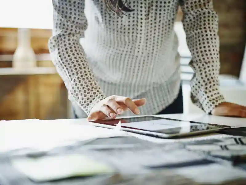Businesswoman looking at digital tablet in office.