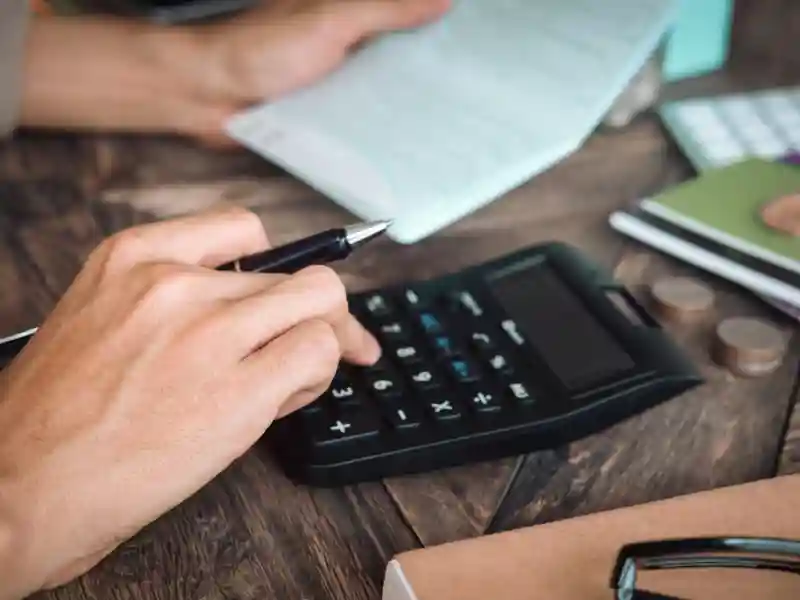 Man using a calculator.