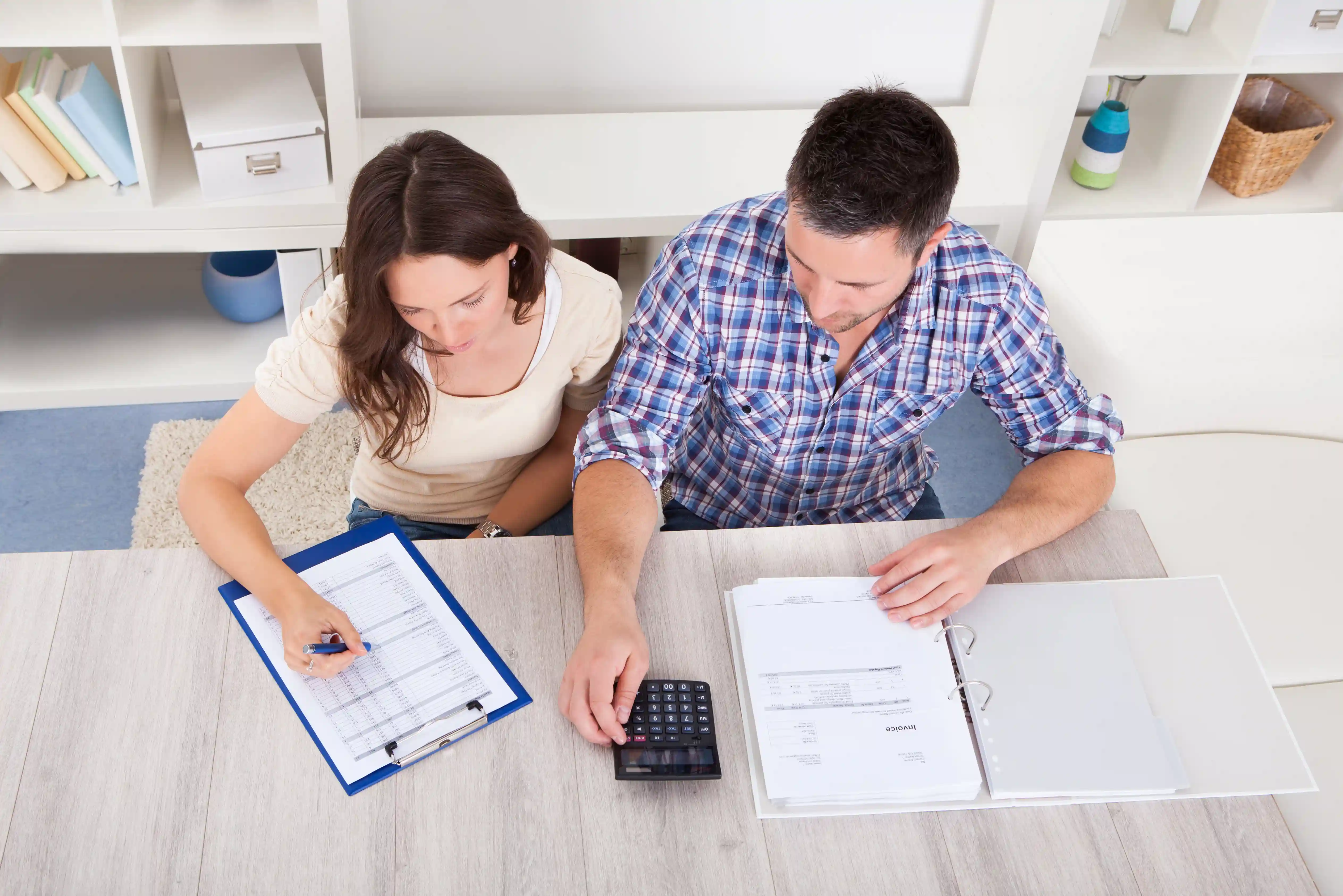 Portrait of a young couple calculating finances at a desk