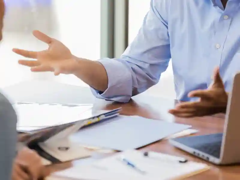 Bank employee discusses loan terms with customer.