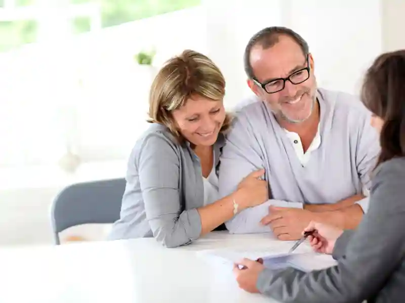 Senior couple signing financial contract.