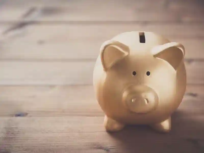 Piggy bank on wood table background.