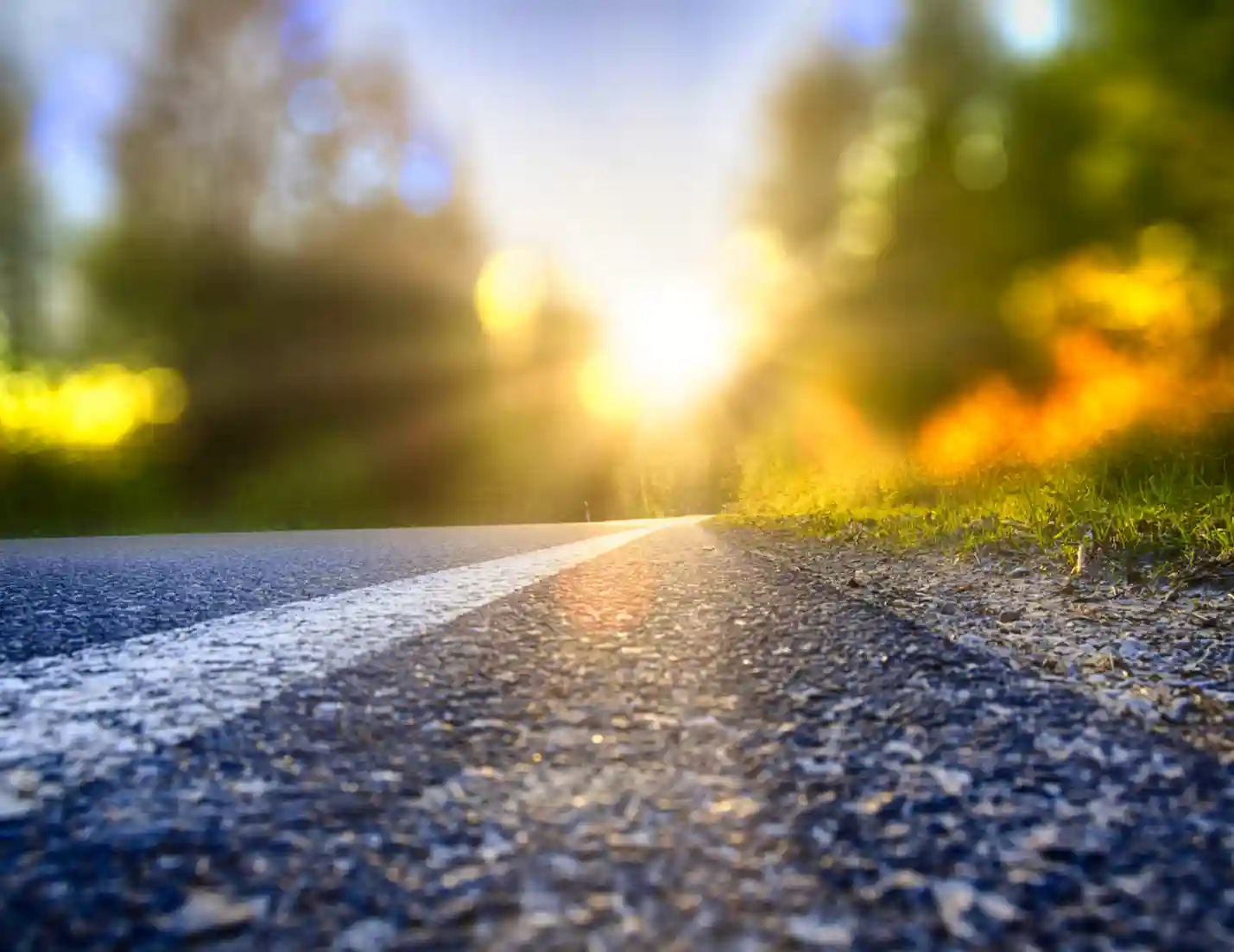 View of road pavement upclose, during sunset.