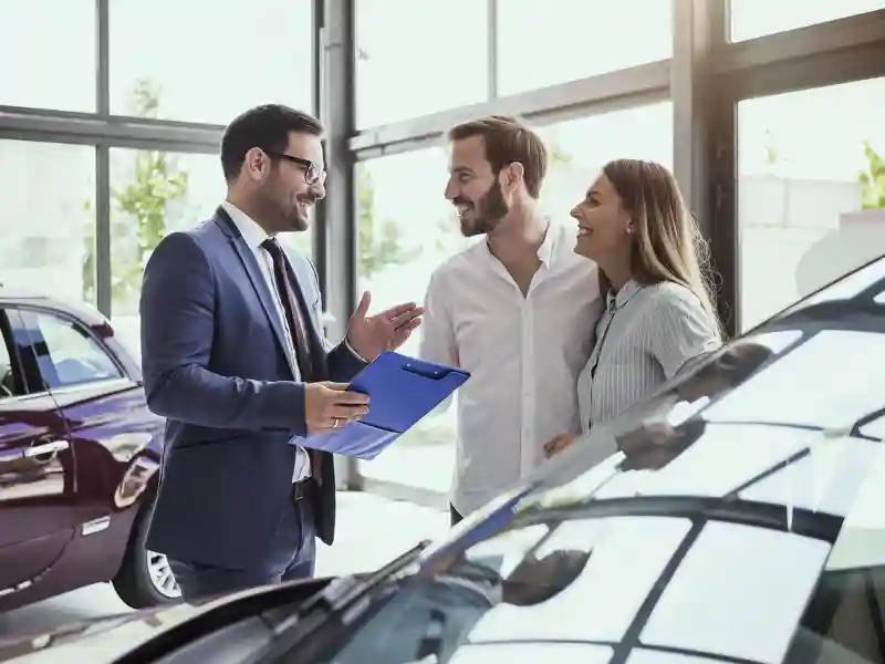 Young couple buying a car.
