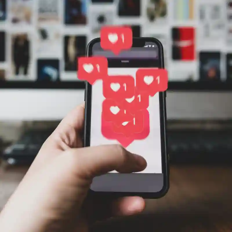 Person holding a smart phone with social media buttons animating up.
