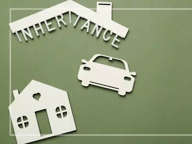 Illustration of a house, car, and roof with the word Inheritance, set on a green background.