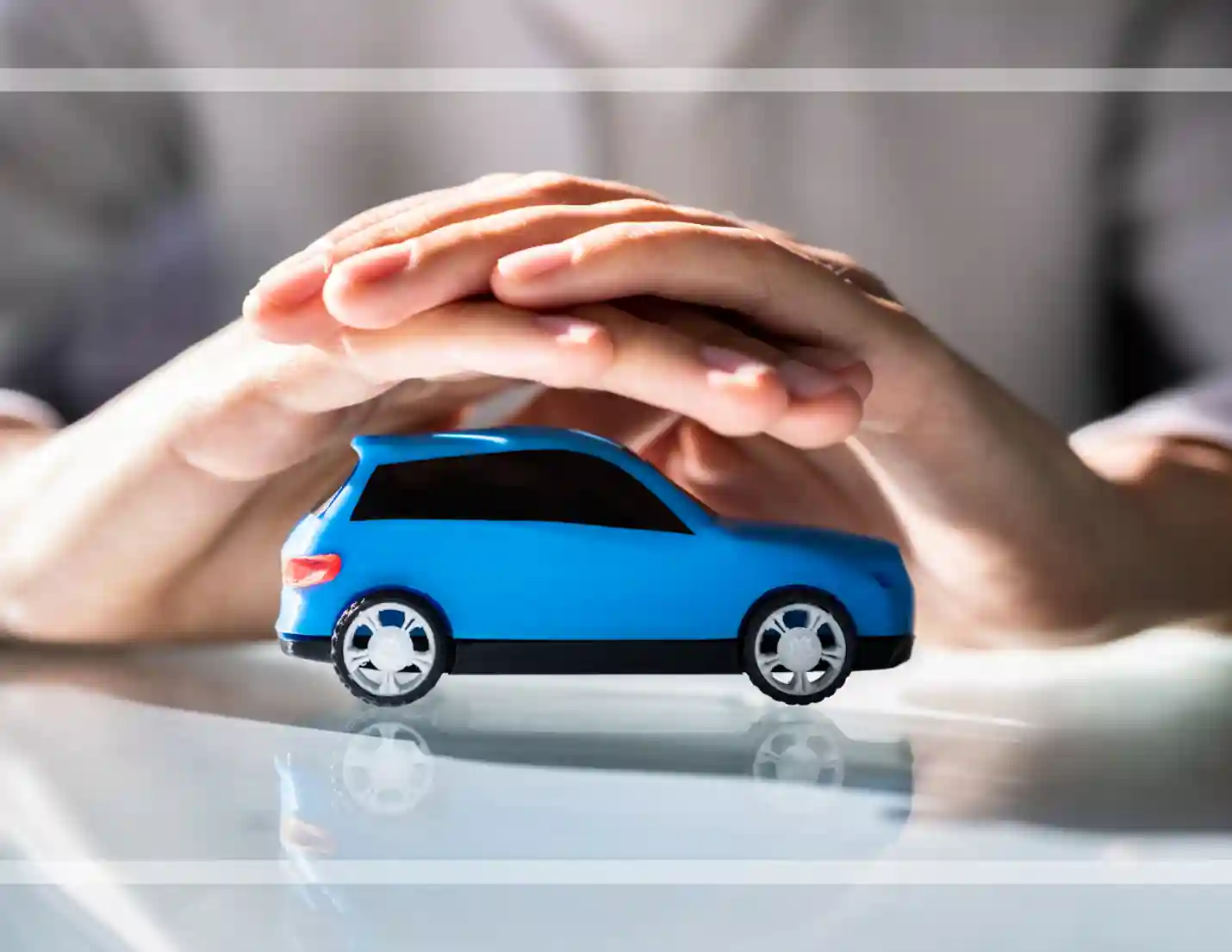 Toy car under hands.