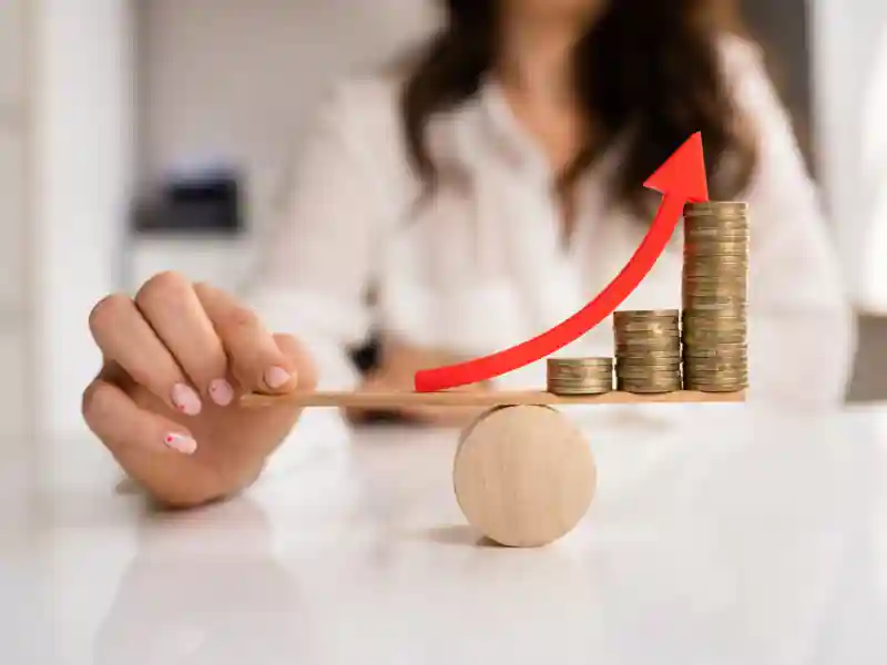 Woman balancing coins on a table.