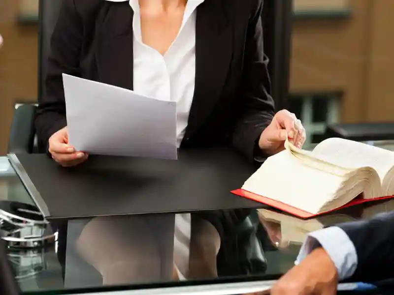 Mature female lawyer or notary with client in her office for counseling.