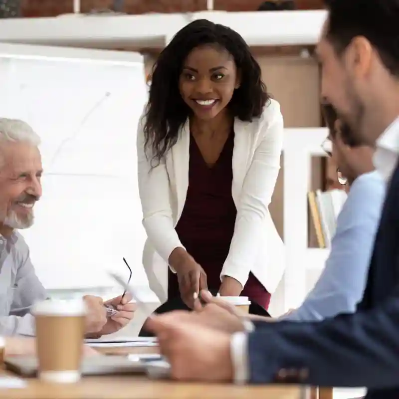 Different ethnicity and age businesspeople gathered together at boardroom for negotiations and planning