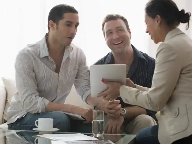 Couple talking to a businesswoman.