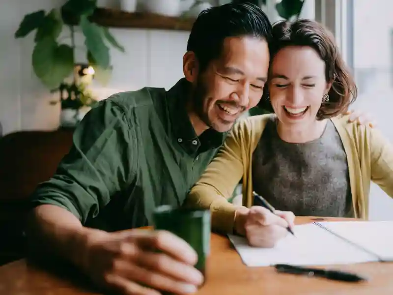 Cheerful couple planning their future home.