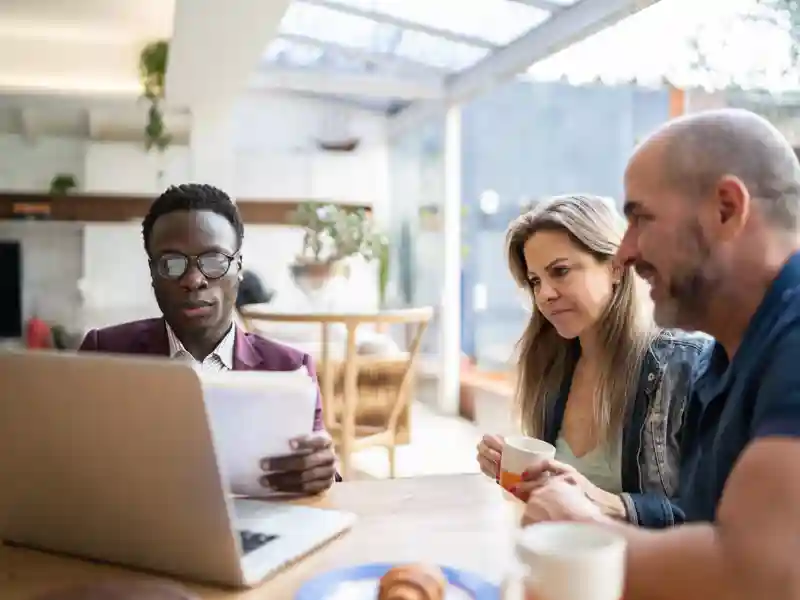 Financial advisor having a meeting with couple at home.