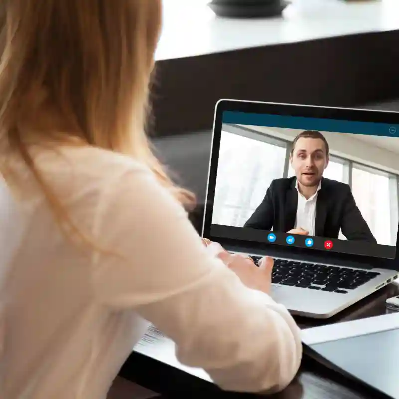 Businesswoman making video call to business partner using laptop, looking at screen with virtual web chat