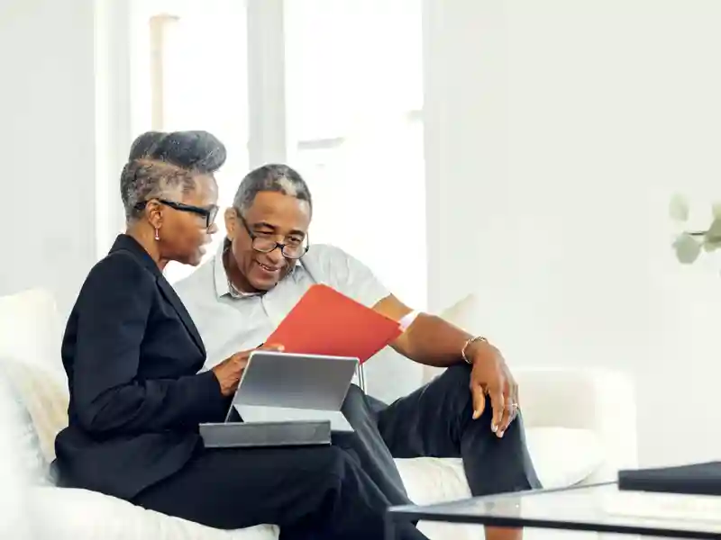 Mature man meeting with financial advisor at home.